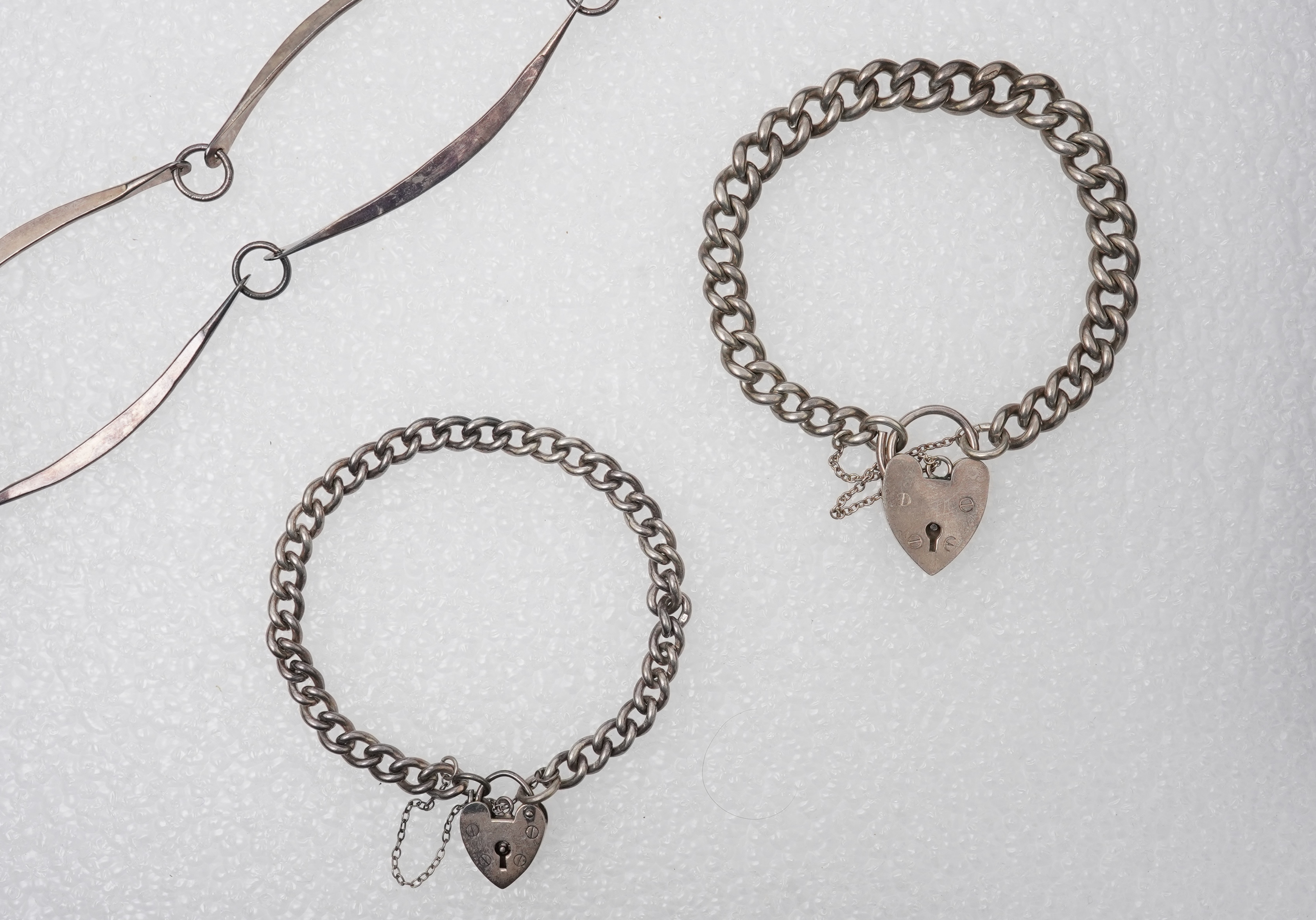 A 1960'sGeorg Jensen silver tie clip, design no. 63, 53mm, together with a stylish sterling necklace and two silver curb link bracelets.